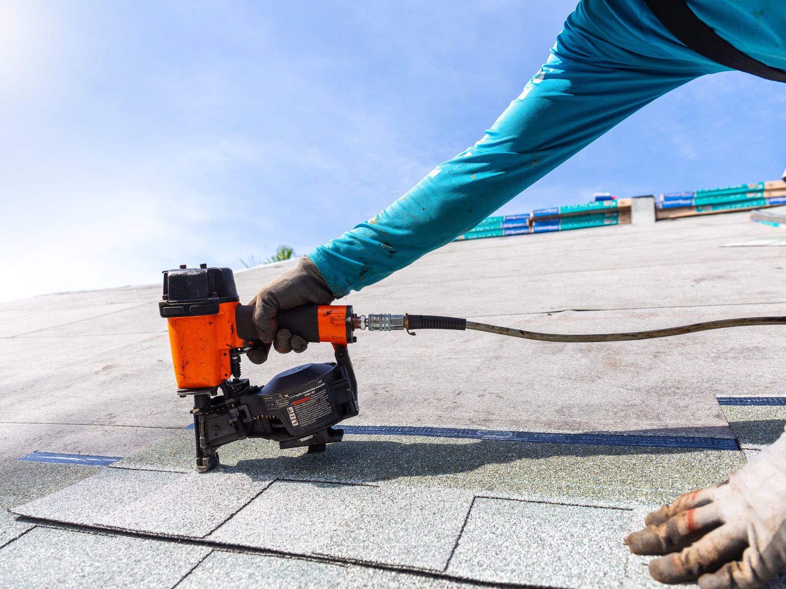 Blackfoot installer nailing new architectural shingles.