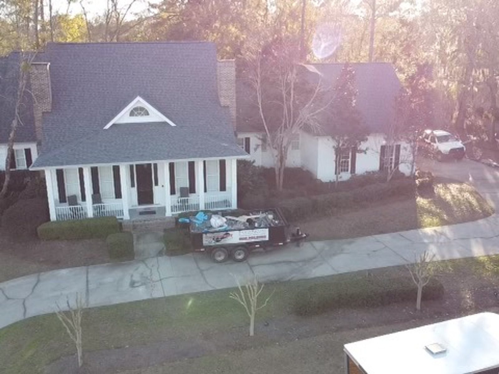 Aerial view of a completed Blackfoot Roofing job — new architectural shingles under a clear North Florida sky.