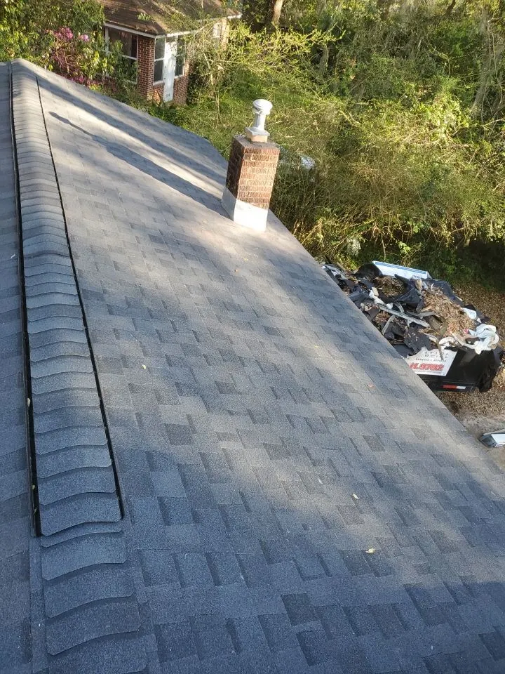 Close-up of finished architectural shingles with the Blackfoot truck below.